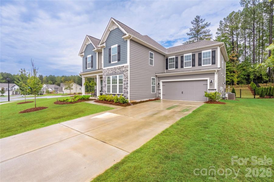 Front exterior of a new home in , Troutman, NC, highlighting curb appeal (Image 23).