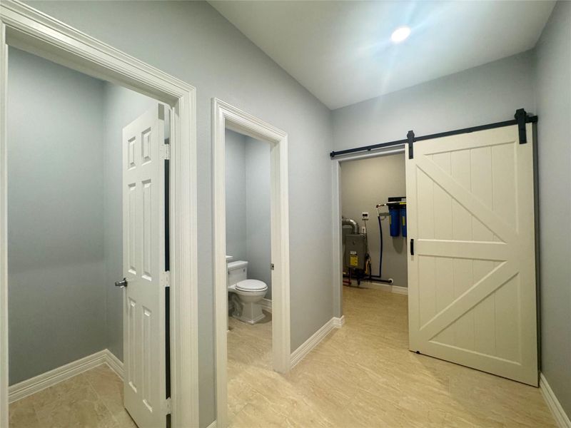 Storage/coat closet on left, powder room in middle, utility room on right