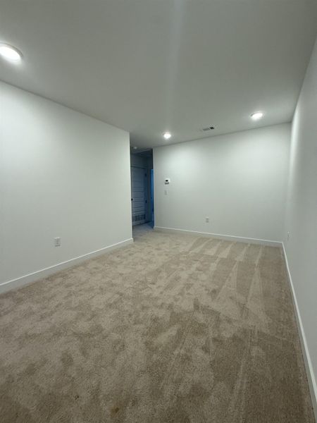 Empty room featuring recessed lighting and light colored carpet