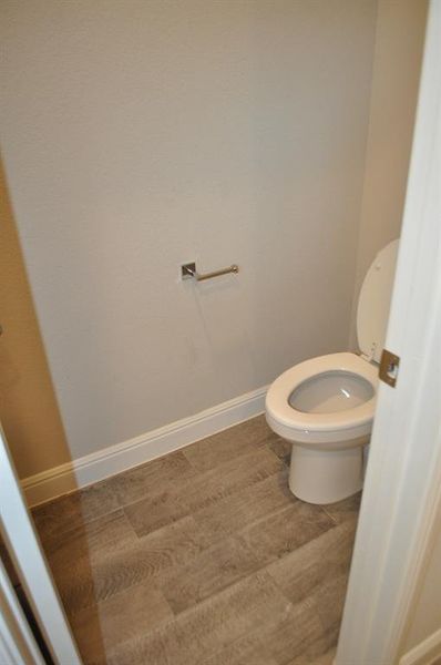 Bathroom featuring hardwood / wood-style floors and toilet