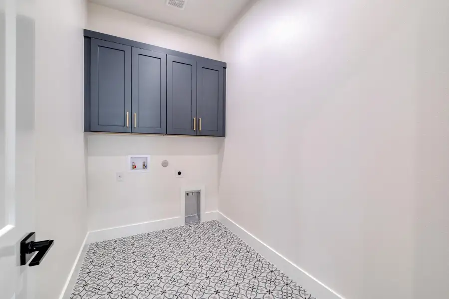 Washroom featuring washer hookup, cabinet space, baseboards, and hookup for an electric dryer