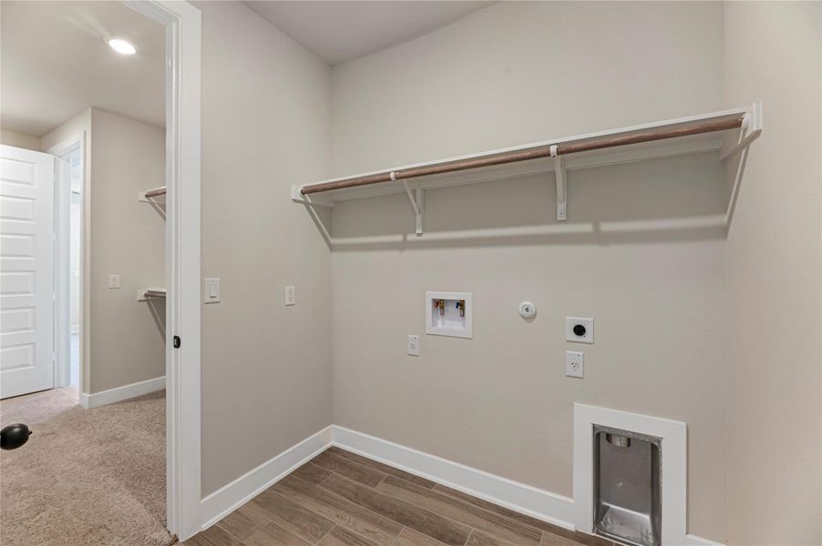Laundry room featuring hookup for a gas dryer, light wood-style floors, washer hookup, hookup for an electric dryer, and recessed lighting