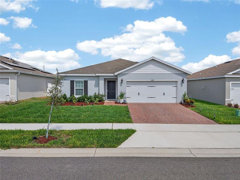Front exterior of a new home in Laurel Glen, Haines City, FL, highlighting curb appeal (Image 25).