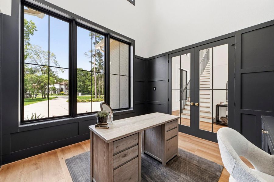 Stately home office with great views out of the triple black framed windows. Stately home office with great views out of the triple black framed windows.