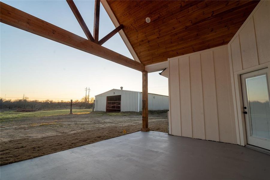 View of patio featuring an outbuilding