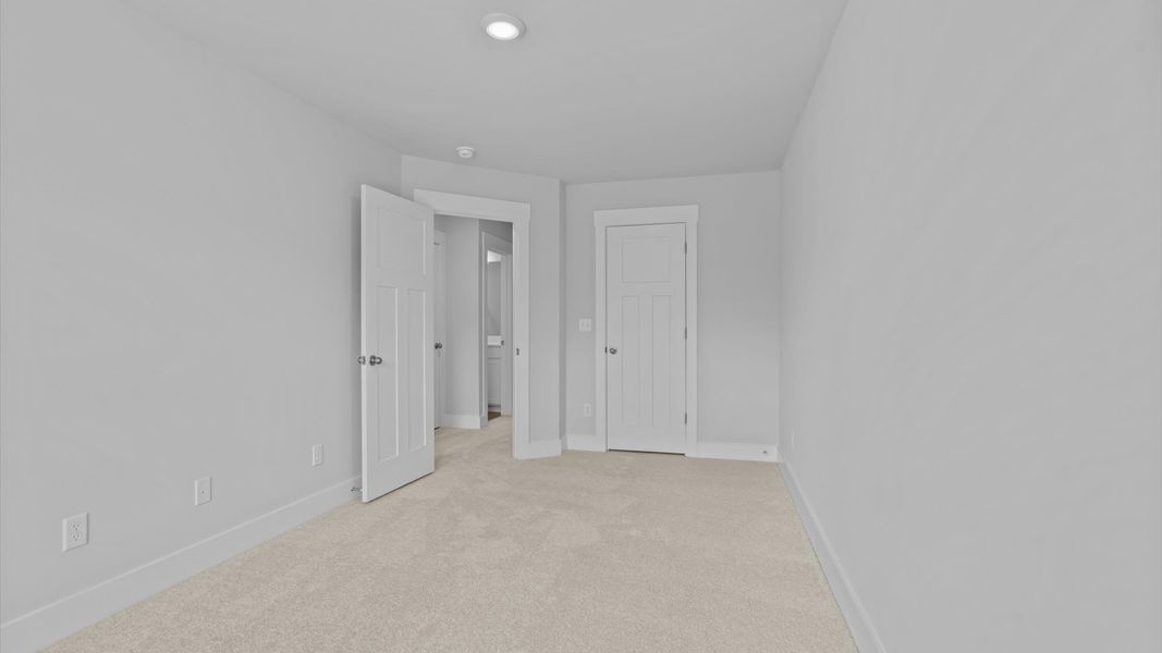 First-rate secondary bedroom with a spacious walk-in closet and elegant carpeted flooring First-rate secondary bedroom with a spacious walk-in closet and elegant carpeted flooring