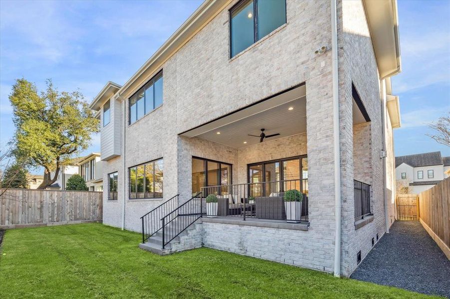 BACKYARD/REAR ELEVATION: Designed with entertaining in mind, the backyard becomes an enchanting retreat for both intimate gatherings and larger celebrations. Imagine hosting al fresco dinners under the stars or lounging in the shade of a thoughtfully designed vreranda.. STUNNING!