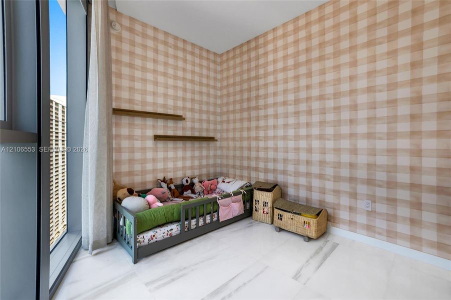 Floor-to-ceiling windows, white stone flooring, patterned wall covering, and dual wall-mounted floating shelves