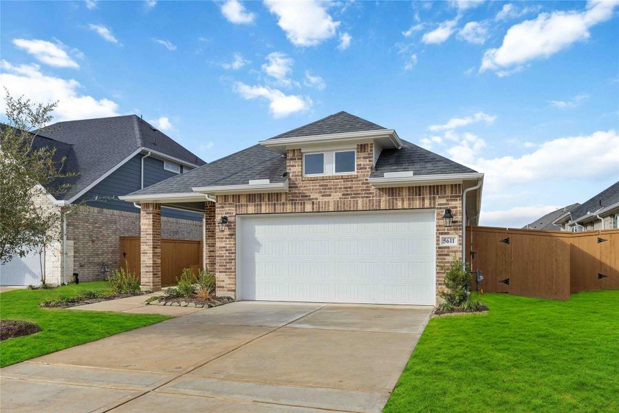 Front exterior of a new home in Sunterra, Katy, TX, highlighting curb appeal (Image 2). Front exterior of a new home in Sunterra, Katy, TX, highlighting curb appeal (Image 2).