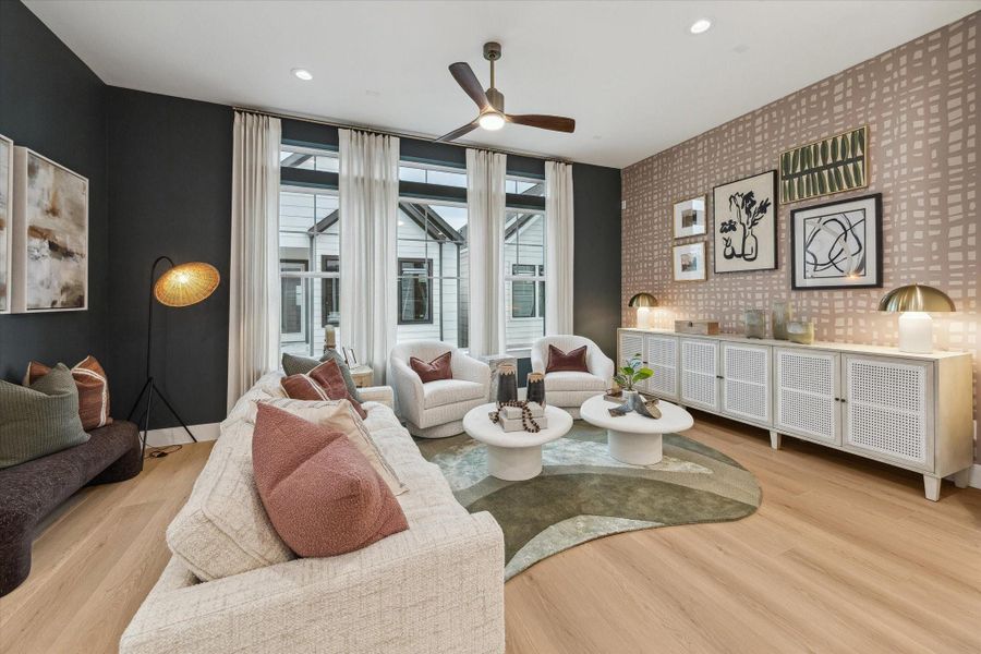 Open living room with oversized windows and natural light Open living room with oversized windows and natural light