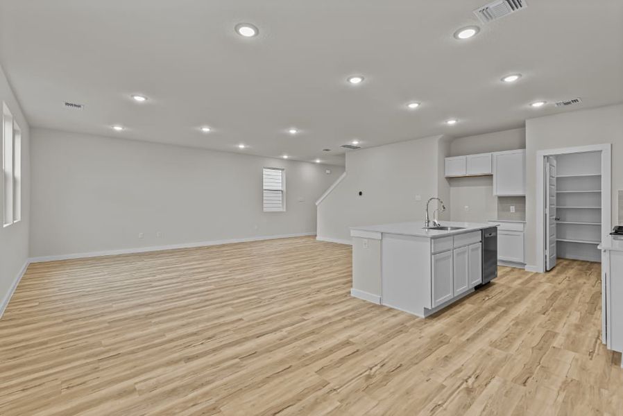 A kitchen with white cabinets.