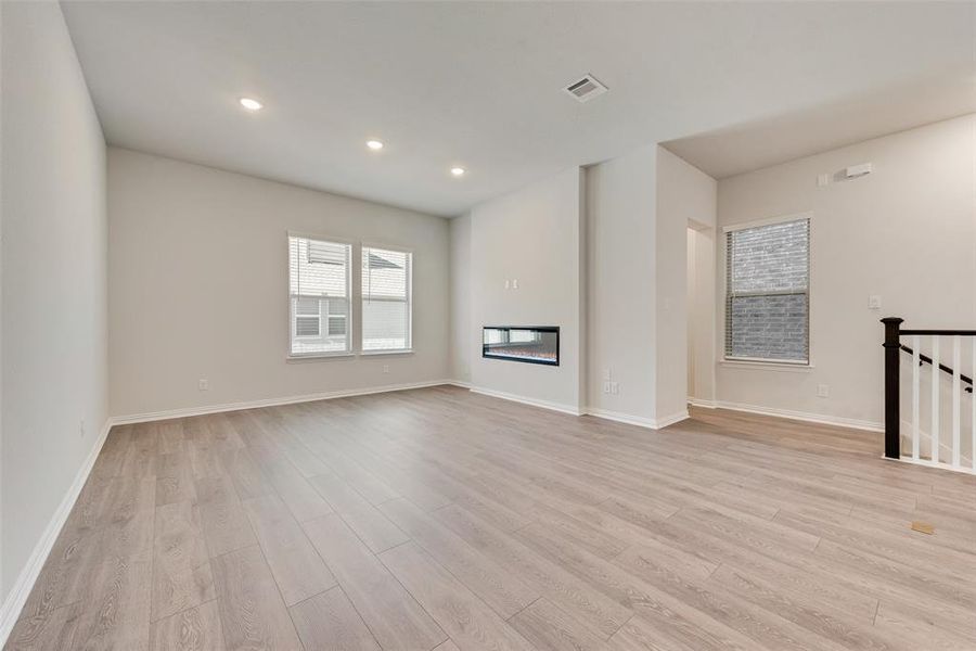 Unfurnished living room with light hardwood / wood-style flooring