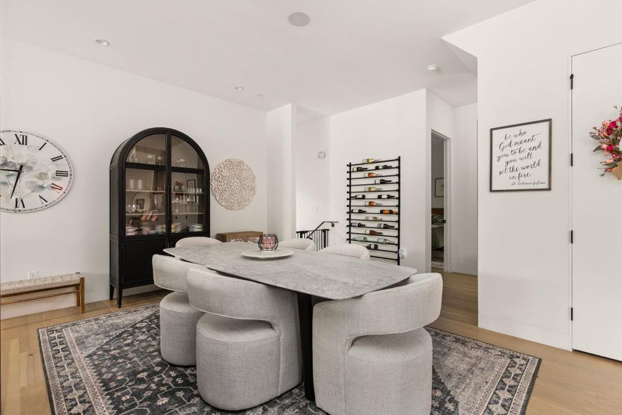 Recessed lighting illuminates this inviting dining area with hardwood floors, ideal for gatherings. Recessed lighting illuminates this inviting dining area with hardwood floors, ideal for gatherings.