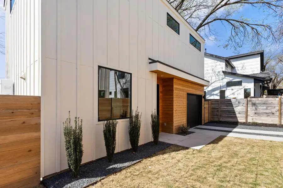 View of home's exterior with a garage and fence