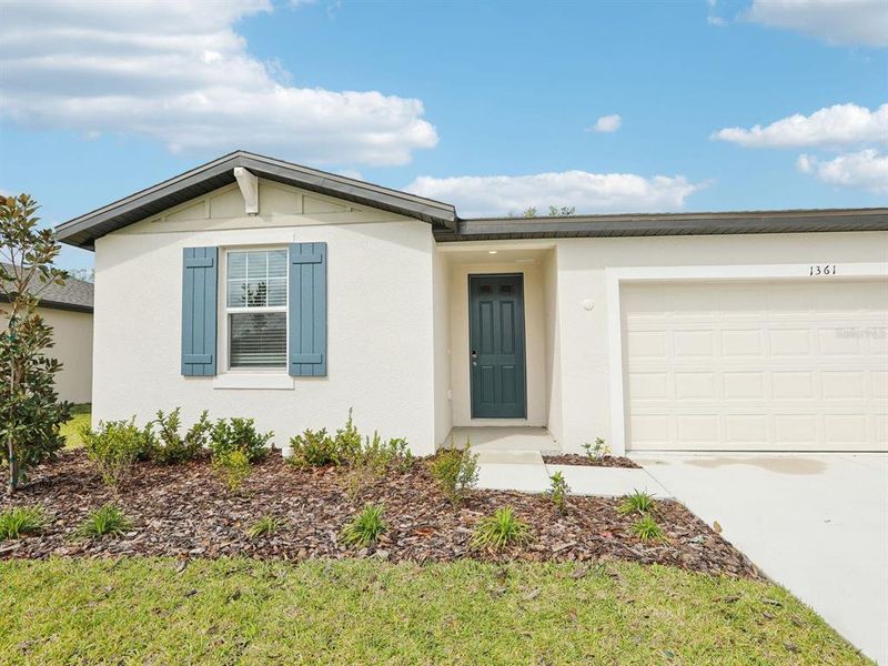 Front exterior of a new home in The Reserve at Van Oaks, Auburndale, FL, highlighting curb appeal (Image 22).