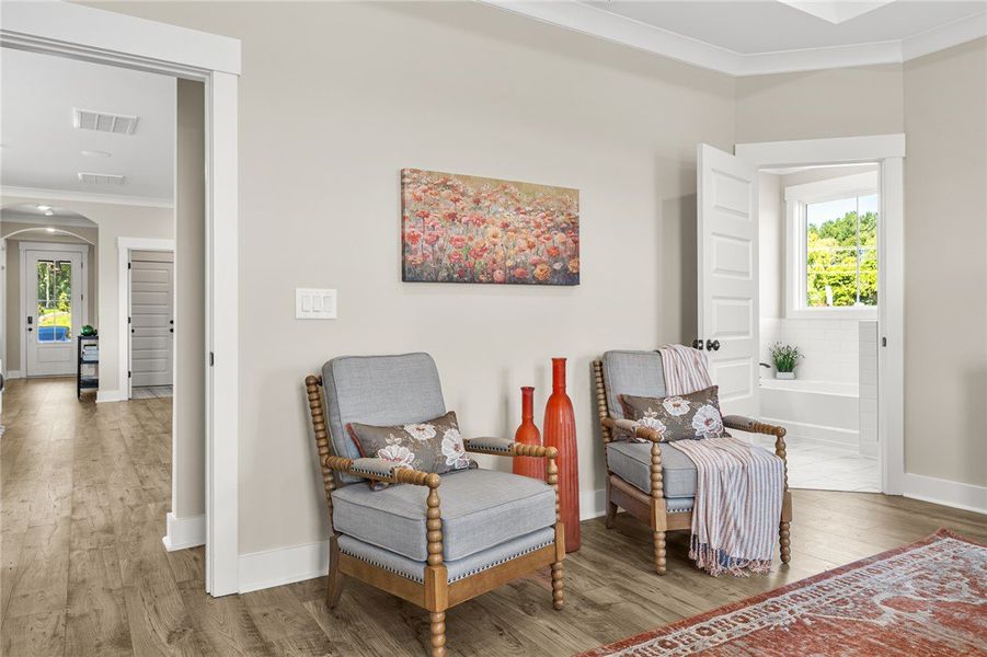 This cozy sitting area features elegant flooring a