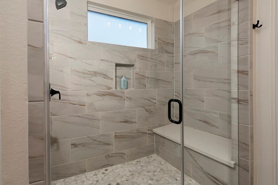 Upgraded tile flooring in large primary shower w seat Upgraded tile flooring in large primary shower w seat