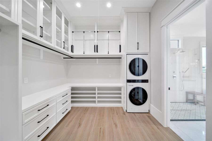A Primary Suite Closet with built in Washer/Dryer! Display case shelving for storing those treasured personal items.  Pull down racks to store those seasonal items and plenty of drawers to hide away anything from jewelry to socks and more.