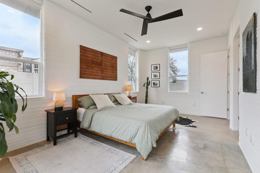 Bedroom featuring concrete flooring, a ceiling fan, and recessed lighting