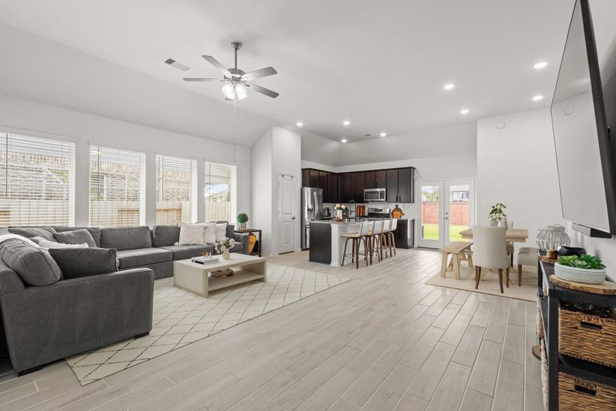 Walking in, you are greeted by a light and open space! This huge living and dining area will not disappoint and offers high ceilings, recessed lighting, a ceiling fan, and large windows letting in tons of natural light. *This photo has been partially virtually staged to show the rooms possibilities.