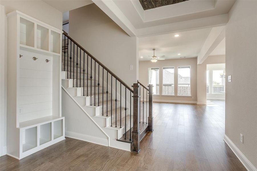 Stairs featuring wood-type flooring and ceiling fan