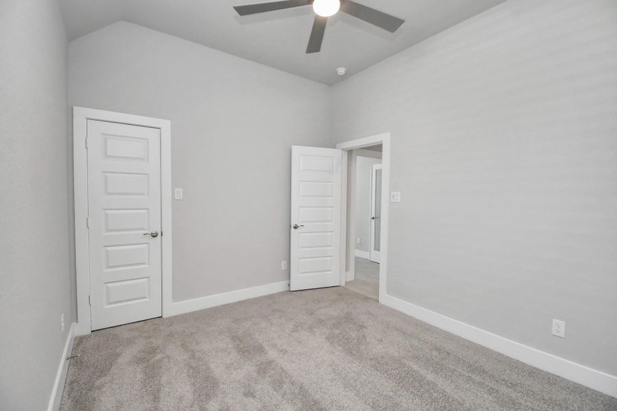 Generously sized secondary bedrooms featuring spacious closets, soft and inviting carpeting underfoot, large windows allowing plenty of natural light, and the added touch of privacy blinds for your personal retreat. Sample photo of completed home with similar floor plan. Actual colors and selections may vary.