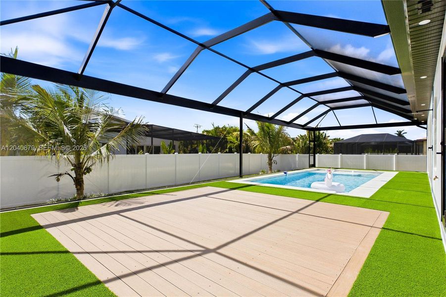 Covered outdoor kitchen and seamless indoor-outdoor flow make this backyard paradise ideal for gatherings with family and friends