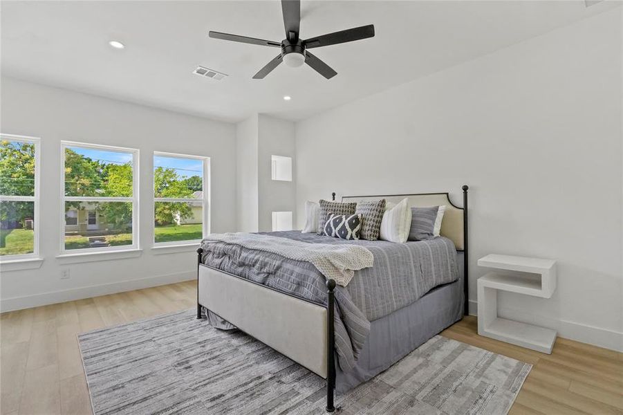 Bedroom featuring recessed lighting, a ceiling fan, and light wood-style flooring Bedroom featuring recessed lighting, a ceiling fan, and light wood-style flooring