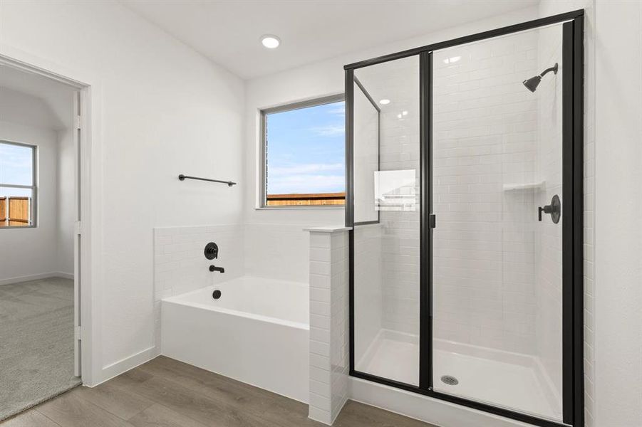 Primary Bathroom featuring walk-in shower and garden tub Primary Bathroom featuring walk-in shower and garden tub