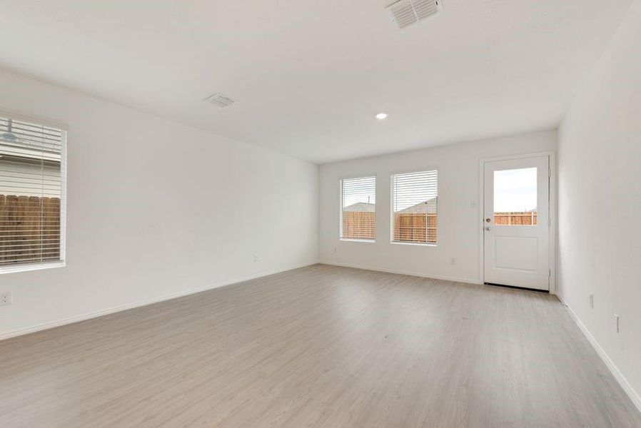 Empty room with baseboards, recessed lighting, visible vents, and light wood-style floors