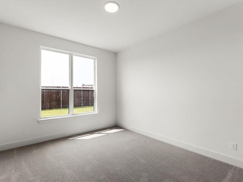 Spare room featuring carpet floors and baseboards Spare room featuring carpet floors and baseboards