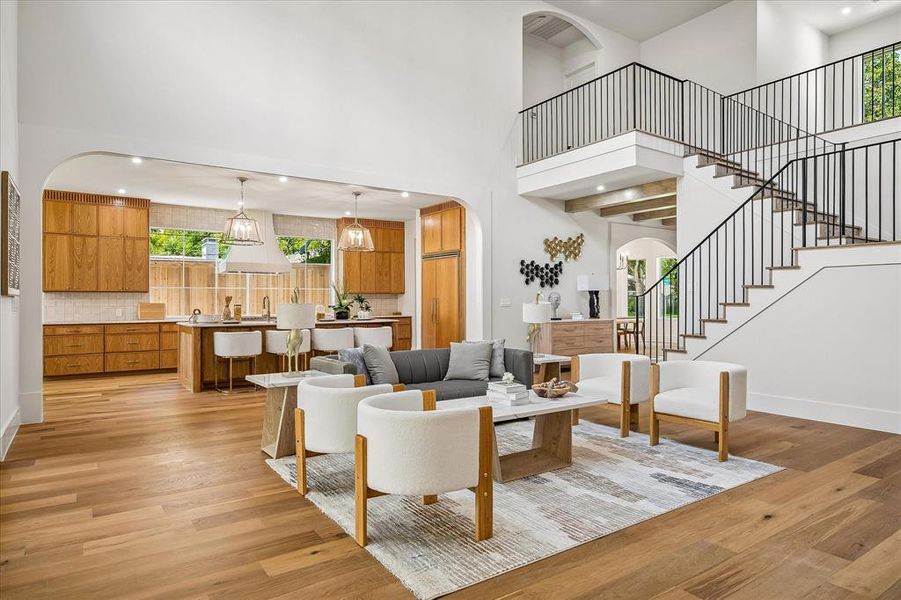 Open living and kitchen, arched transition, custom oak cabinetry, iron stair railing Open living and kitchen, arched transition, custom oak cabinetry, iron stair railing