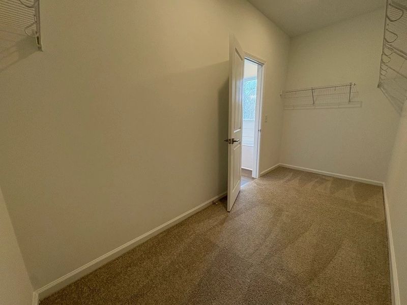 Primary Walk-In featuring the AW Collection® Timeless - Organized luxury with timeless appeal.