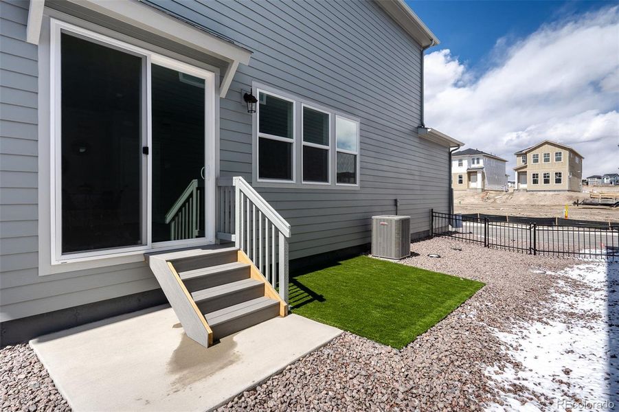 Exterior details and patio area of a home in Revel Crossing at Wolf Ranch – The Ascent Collection, Colorado Springs (Image 25).