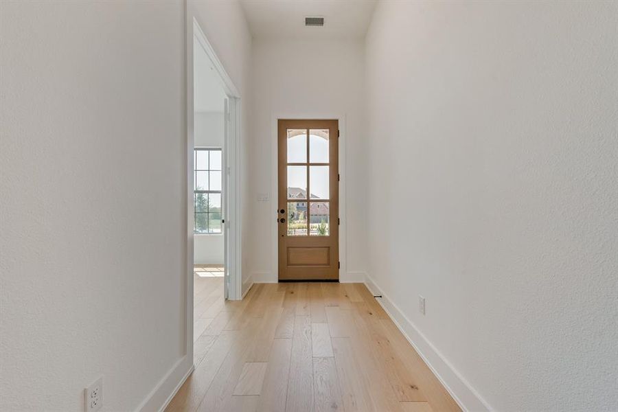 Doorway featuring wood finished floors and baseboards