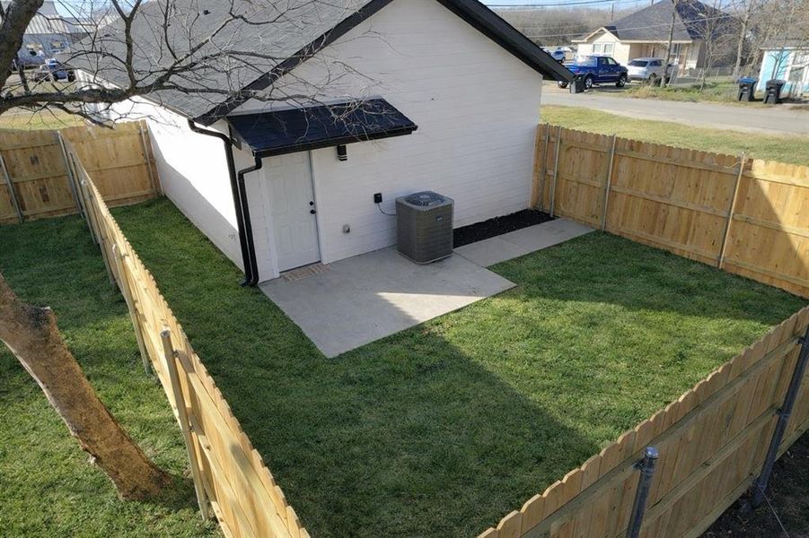 Fenced backyard with a patio area Fenced backyard with a patio area