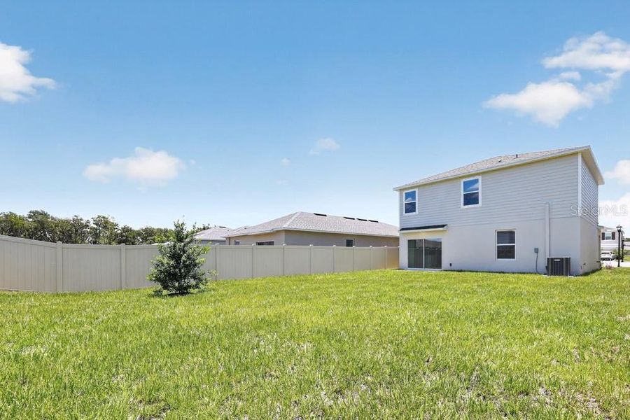Exterior details and patio area of a home in Palm Wind, Hudson (Image 25).