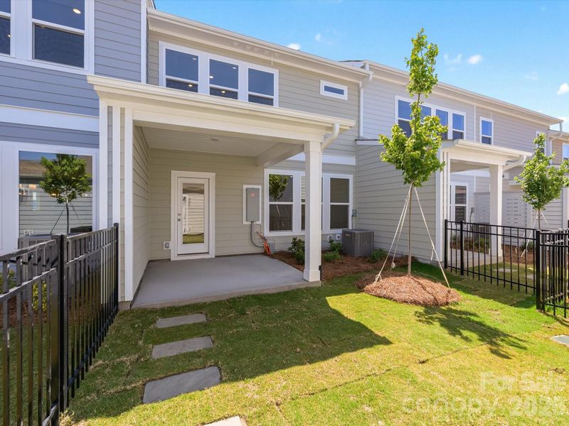 Exterior details and patio area of a home in North Creek Village - Townhomes, Huntersville (Image 3).