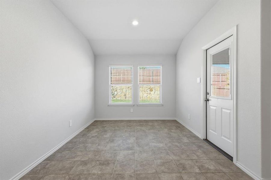 Dining area at rear entry, light tile and recessed lighting Dining area at rear entry, light tile and recessed lighting