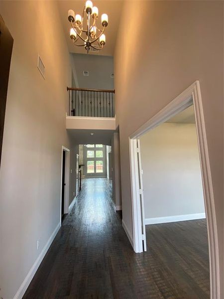 Entry with cathedral ceilings and rich wood floors