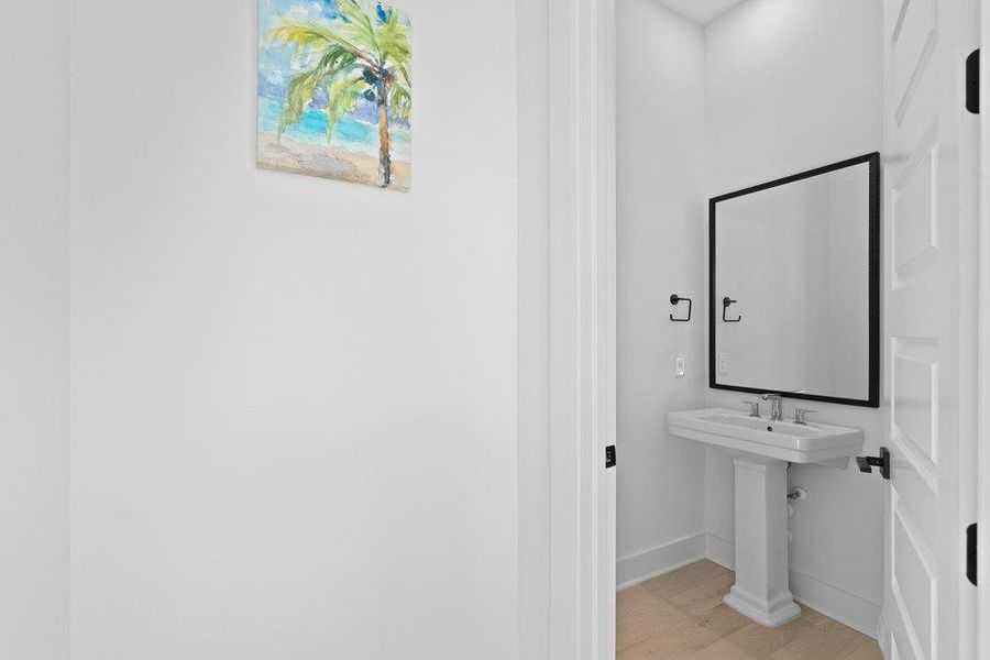 Bathroom featuring light wood-style floors and baseboards