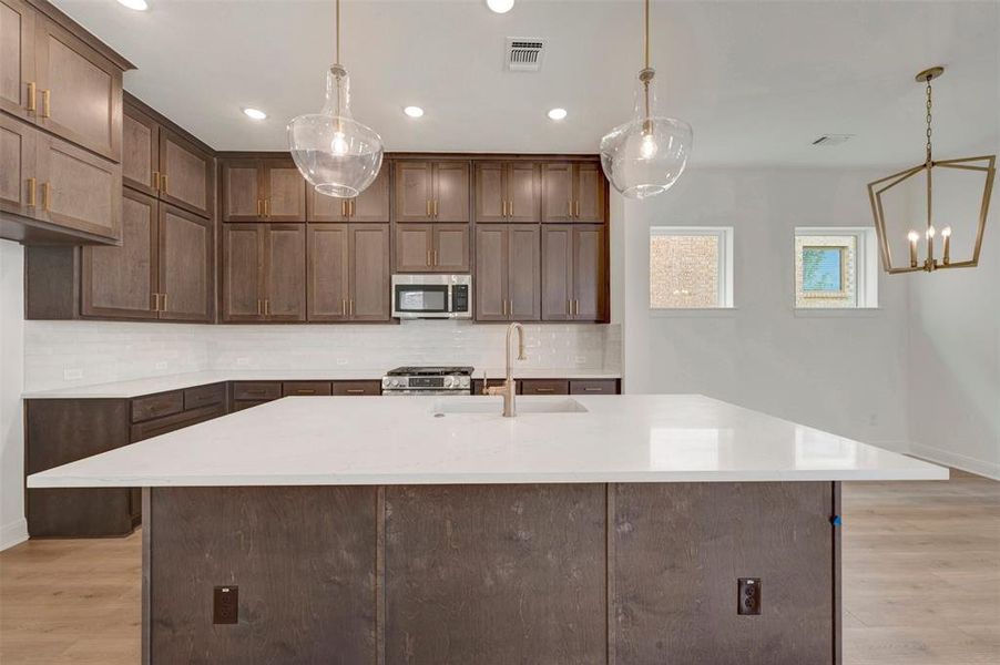 Spacious kitchen island with a white countertop and integrated sink
