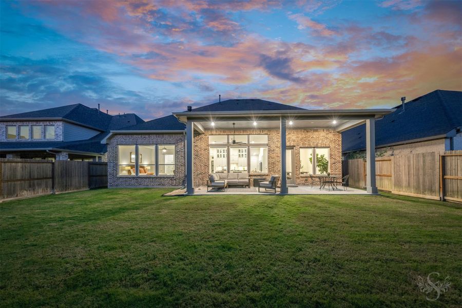 The extended covered patio creates a beautiful outdoor living space with plenty of room for relaxing and entertaining. Beyond the patio, the spacious fenced backyard offers endless possibilities for outdoor enjoyment. The extended covered patio creates a beautiful outdoor living space with plenty of room for relaxing and entertaining. Beyond the patio, the spacious fenced backyard offers endless possibilities for outdoor enjoyment.