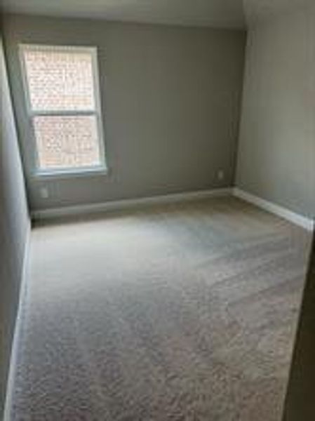 Carpeted spare room featuring a healthy amount of sunlight