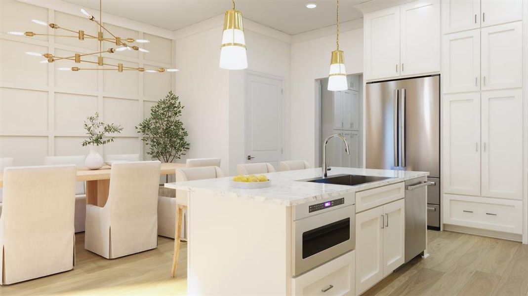 Kitchen with custom cabinetry to the ceiling, island with additional seating and decorative lighting.