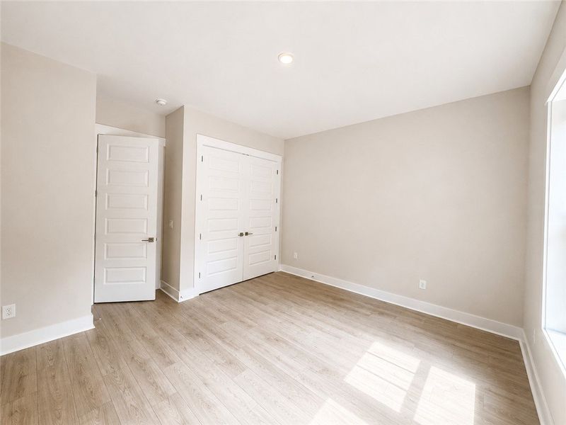 Sun-filled room with light wood-look flooring and