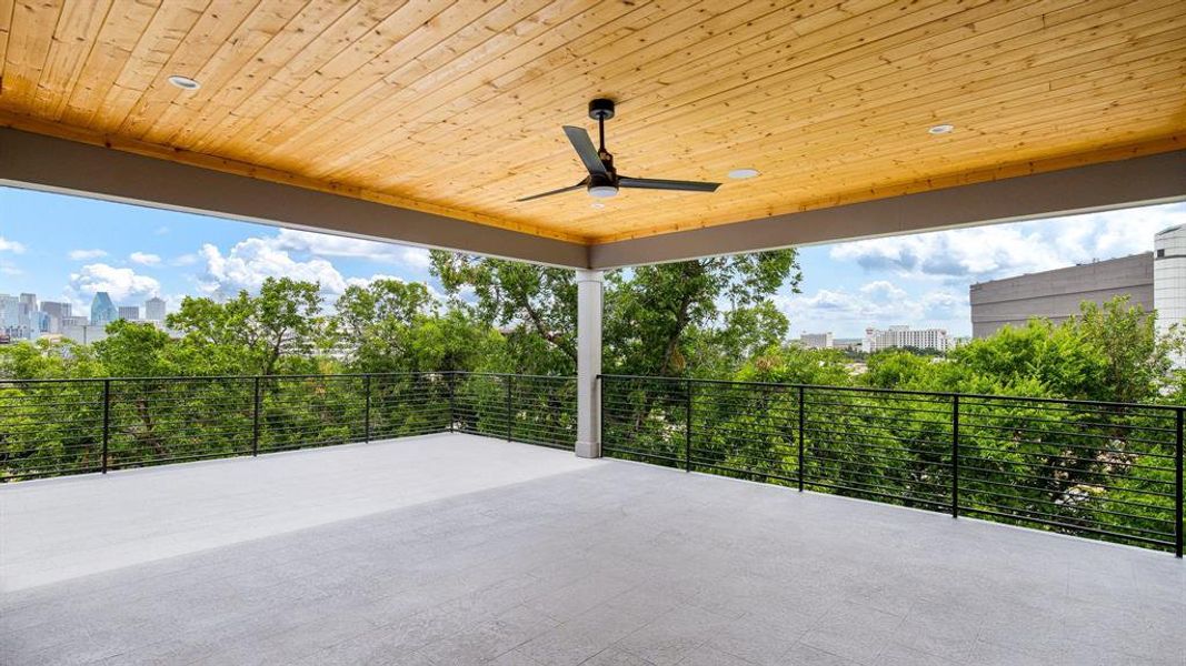 View of patio with a balcony and ceiling fan