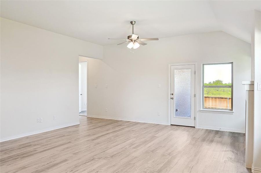 Spare room featuring ceiling fan, light hardwood / wood-style flooring, and lofted ceiling