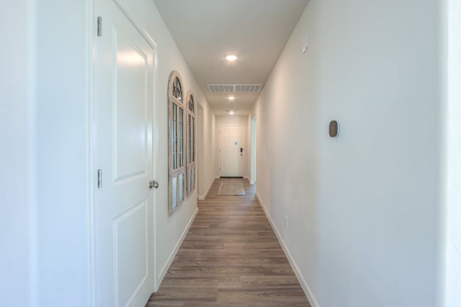 A hallway with white doors.
