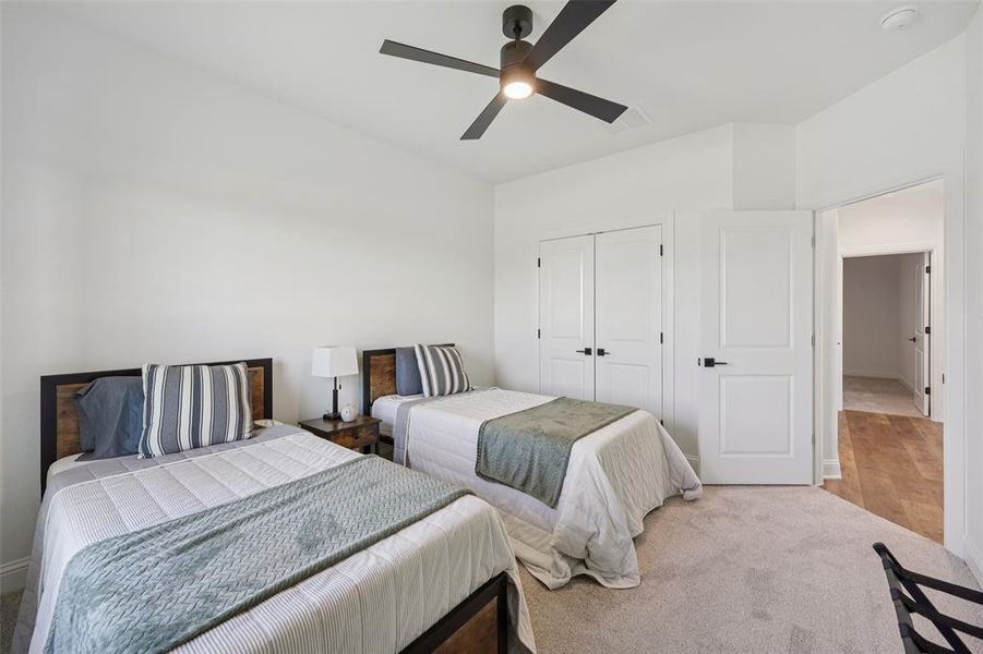 Bedroom with a ceiling fan, a closet, and carpet floors Bedroom with a ceiling fan, a closet, and carpet floors